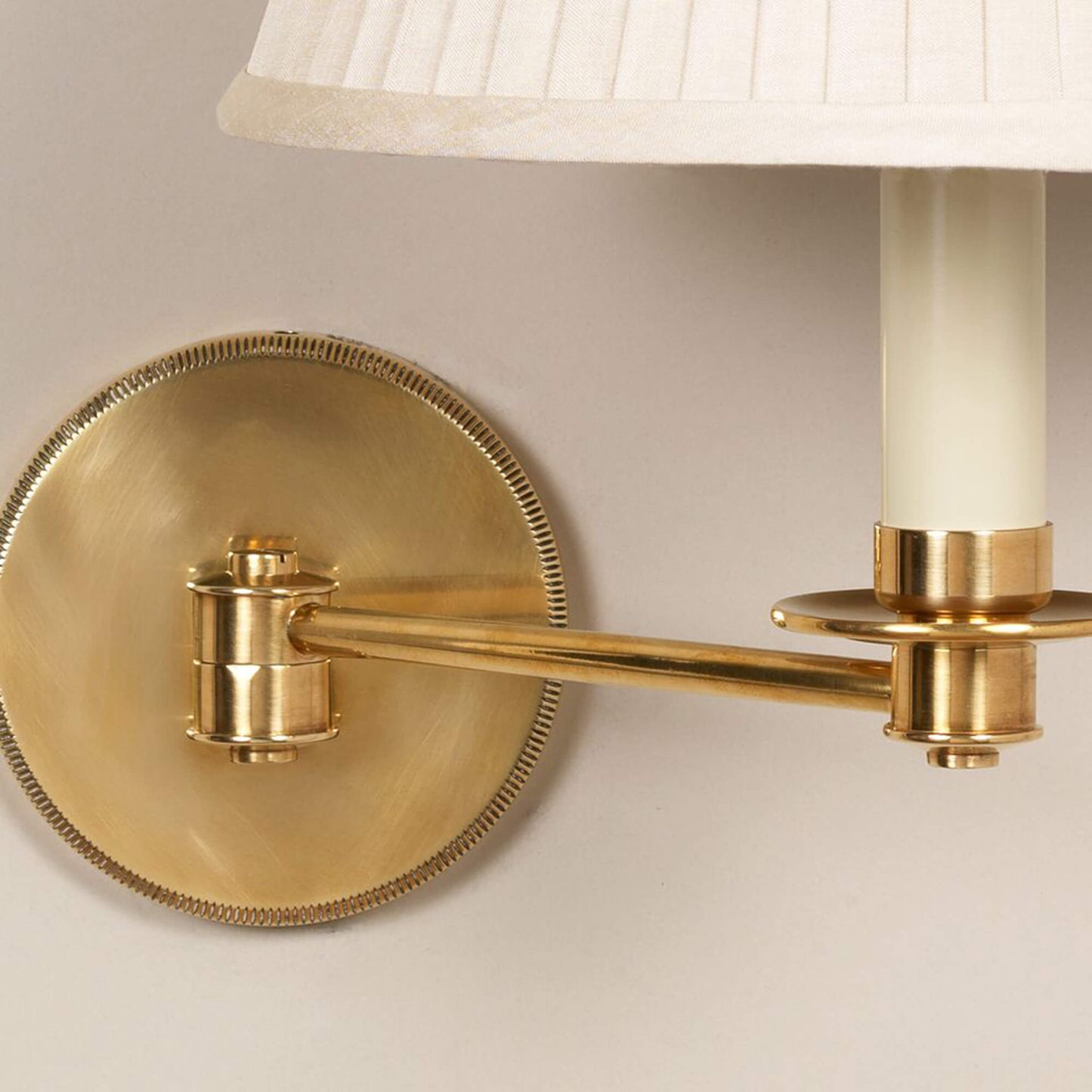 Close up of Cromer swing arm wall light in brass