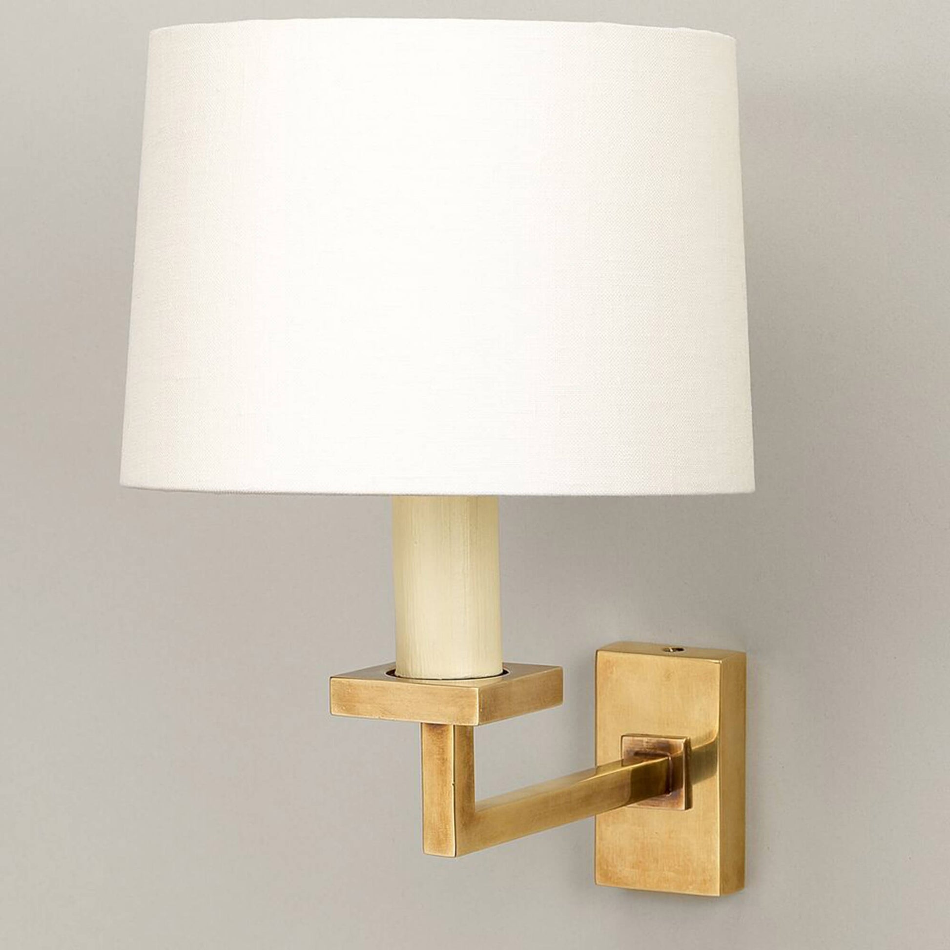 Fixed library wall light in brass with white shade