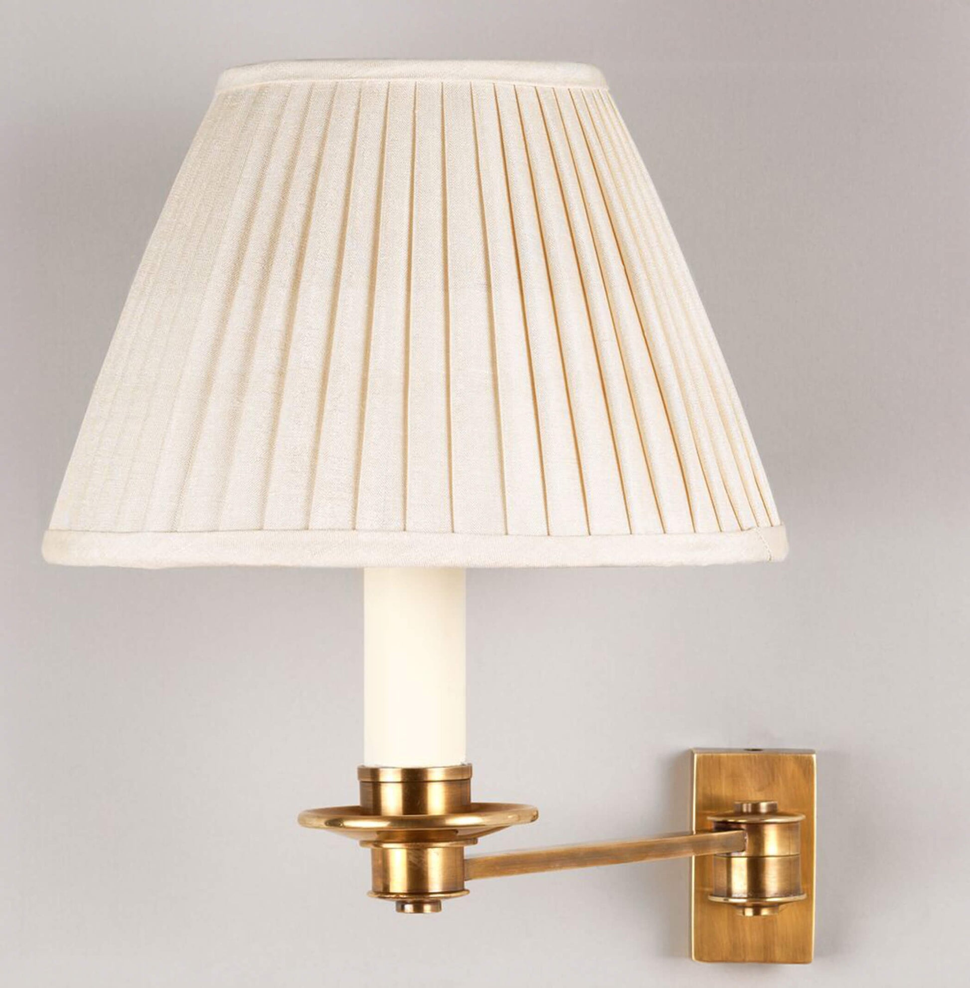 Single arm library wall light in brass with 7" empire knife pleat shade in cream silk