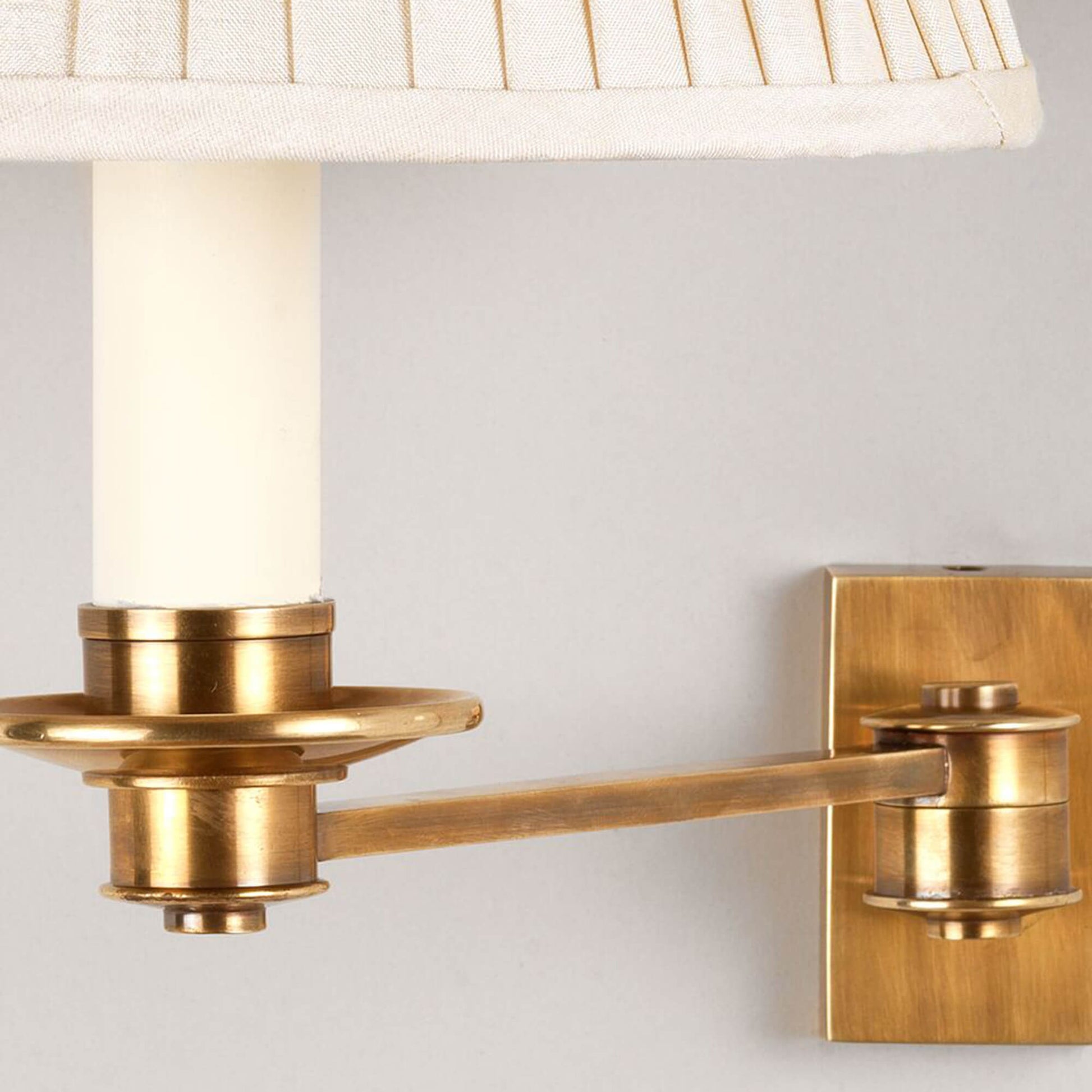 Close up of library single arm wall light in brass