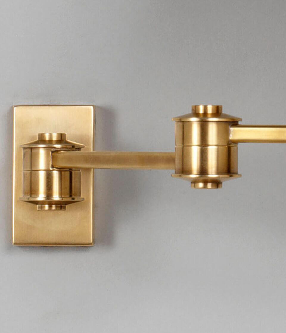 Close of up wall plate and arm in brass for the library swing arm wall light