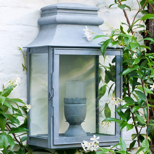 Zinc Valencay lantern mounted on an extetnal wall with planting